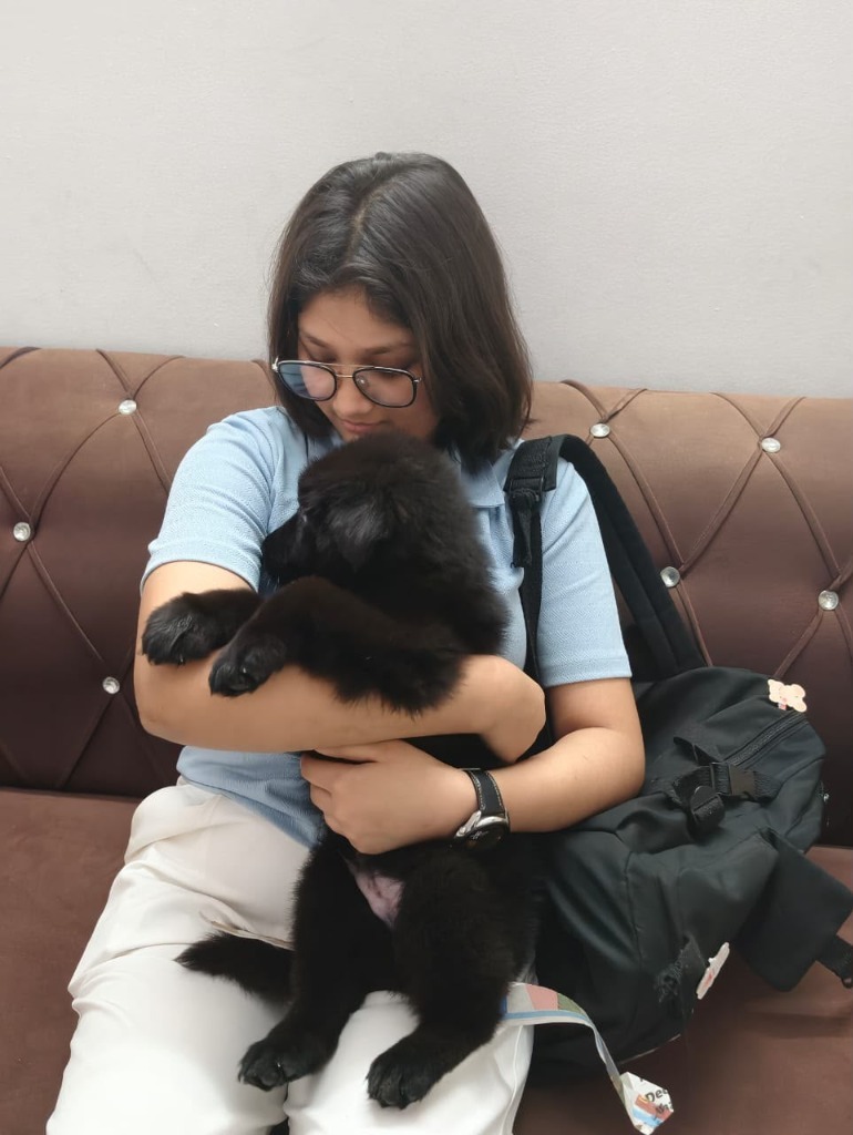 Happy client holding puppy in Delhi